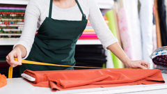 Entrepreneur measuring fabric in a workshop, representing the work of a textile startup developing innovative materials.